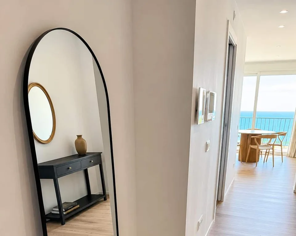 Lo specchio ad arco e la consolle, con il corridoio verso il mare